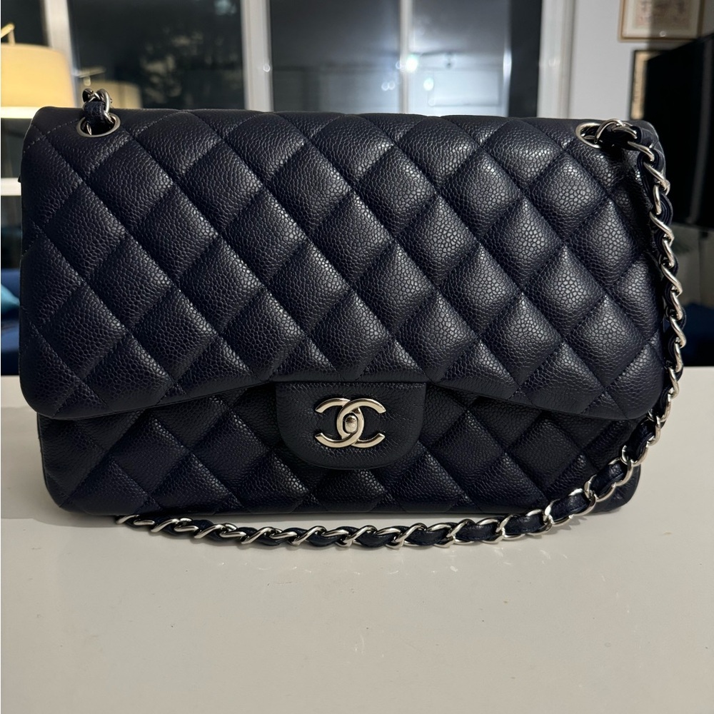 Selling this Chanel Classic Double Flap Jumbo purse. (Navy in silver hardware)